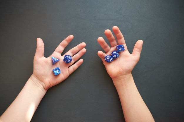 kid holding dices