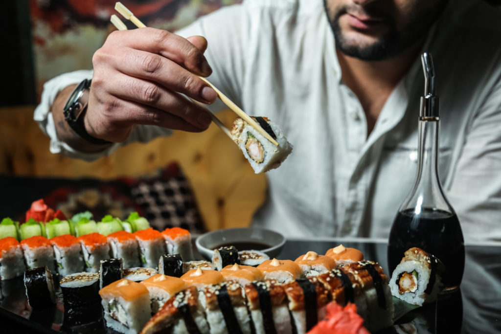 man eating sushi